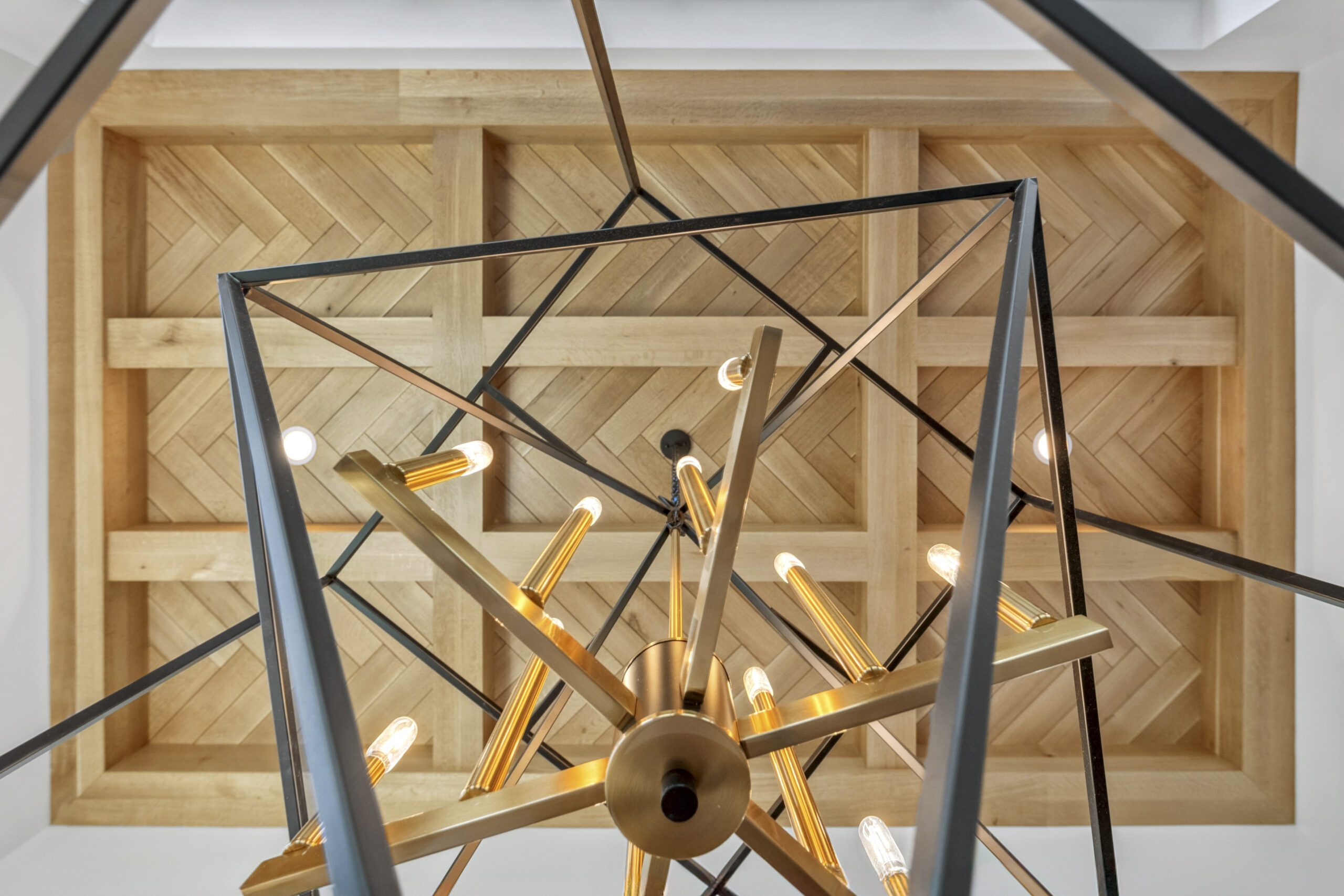 Modern gold and glass globe pendant lighting installed on a custom natural wood plank ceiling with exposed beams by Fort Wayne contractor Home Enterprises Inc.