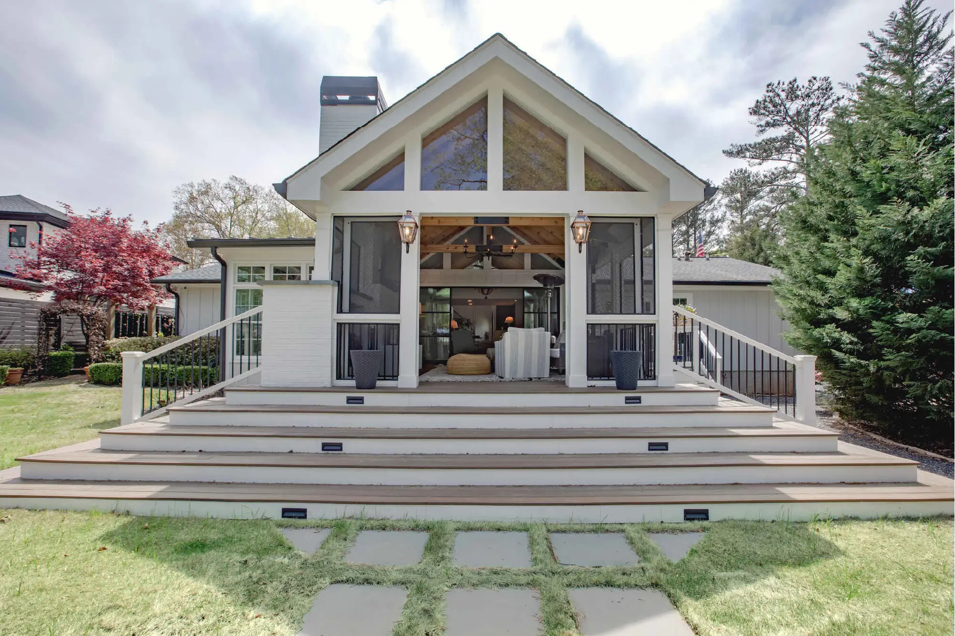 Large, modern craftsman whole-home addition and second-story extension project in Fort Wayne by general contractor Home Enterprises Inc., featuring light gray siding, white trim, and a welcoming front porch.